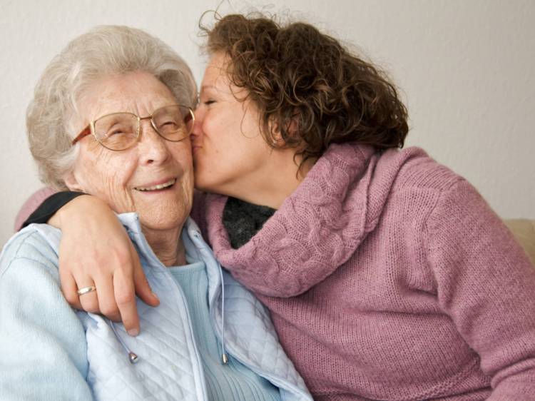 Woman hugging elderly lady